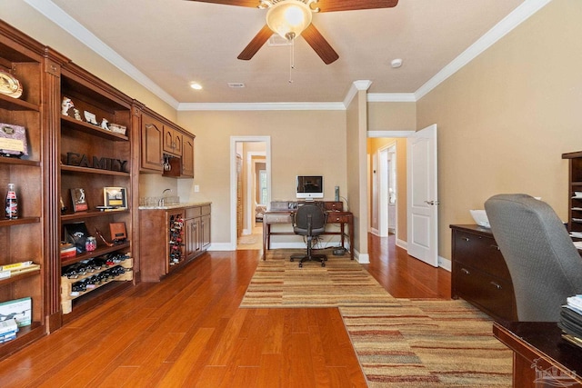 home office featuring ornamental molding, ceiling fan, and dark wood-type flooring