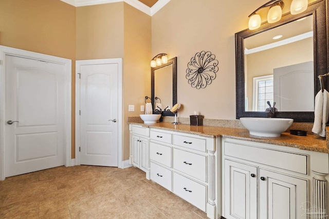 bathroom featuring ornamental molding and vanity