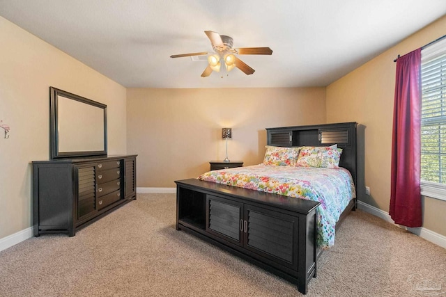 bedroom with ceiling fan and light colored carpet