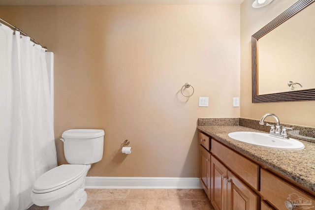 bathroom featuring tile patterned flooring, vanity, and toilet