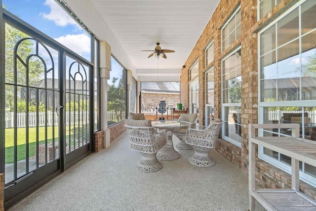 sunroom / solarium featuring ceiling fan