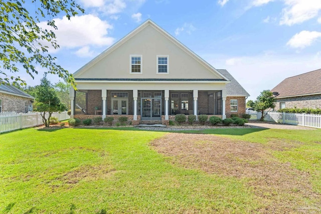 rear view of property with a yard