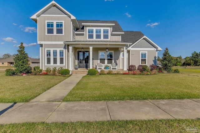 2420 Meeting St, Cantonment, FL 32533 - view of front of home with board and batten siding, a standing seam roof, a porch, and a front lawn