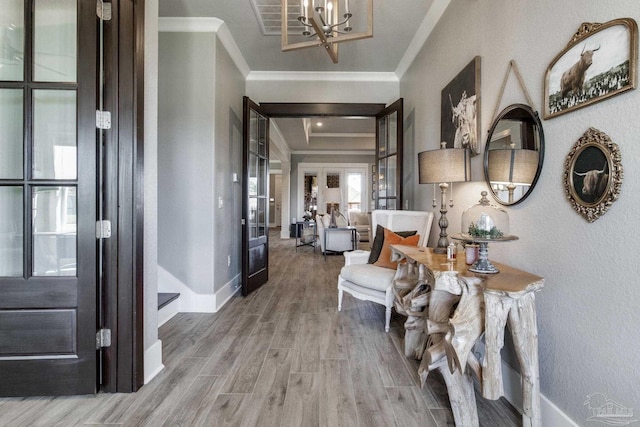 2420 Meeting St, Cantonment, FL 32533 - hall featuring french doors, an inviting chandelier, ornamental molding, and wood finished floors
