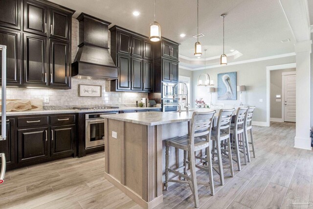 2420 Meeting St, Cantonment, FL 32533 - kitchen with a raised ceiling, light countertops, appliances with stainless steel finishes, premium range hood, and backsplash