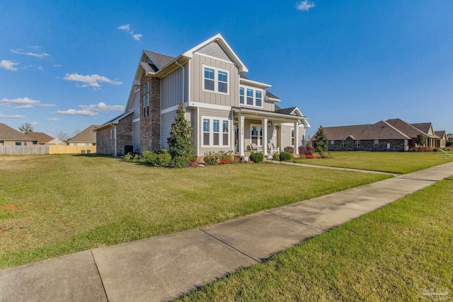 2420 Meeting St, Cantonment, FL 32533 - view of front of home with board and batten siding, a front yard, and fence