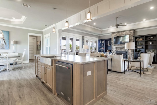 2420 Meeting St, Cantonment, FL 32533 - kitchen featuring crown molding, an island with sink, light wood-style flooring, a ceiling fan, and a raised ceiling