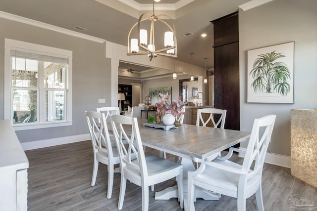 2420 Meeting St, Cantonment, FL 32533 - dining space featuring baseboards, crown molding, ceiling fan with notable chandelier, and wood finished floors