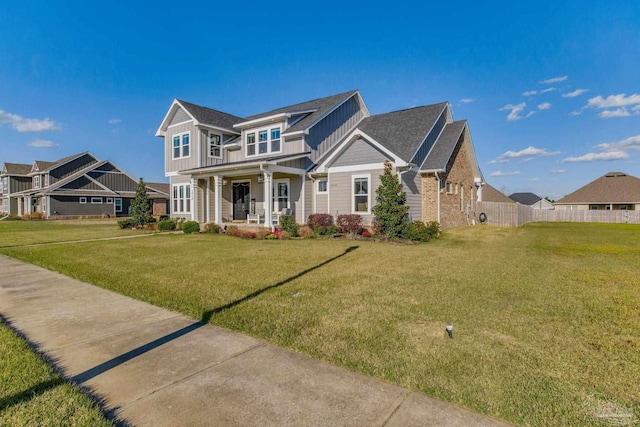 2420 Meeting St, Cantonment, FL 32533 - view of front of home featuring board and batten siding, fence, a front lawn, and covered porch