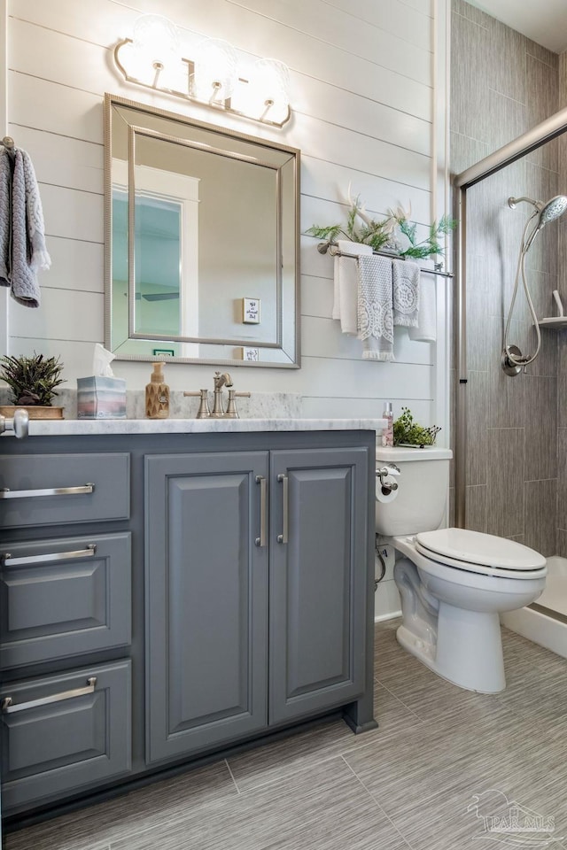 2420 Meeting St, Cantonment, FL 32533 - full bath featuring a shower stall, wood walls, vanity, and toilet