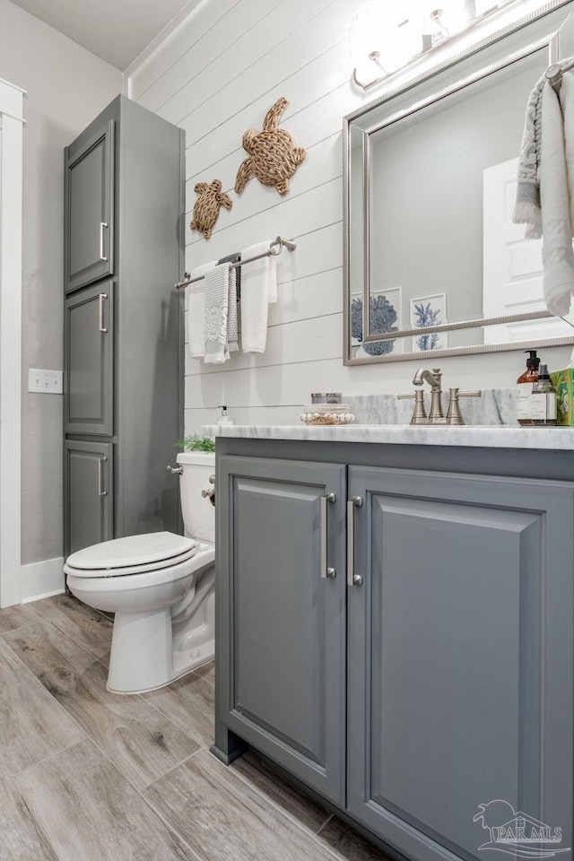2420 Meeting St, Cantonment, FL 32533 - half bath featuring vanity, toilet, and wood finished floors