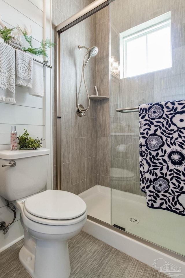 2420 Meeting St, Cantonment, FL 32533 - bathroom featuring tile patterned flooring, toilet, and a stall shower