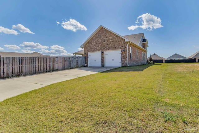 2420 Meeting St, Cantonment, FL 32533 - view of side of property featuring a garage, a yard, fence, brick siding, and concrete driveway