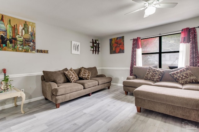 living area with ceiling fan, baseboards, and wood finished floors