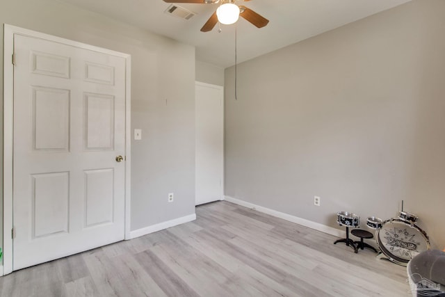 unfurnished room with a ceiling fan, light wood-style flooring, baseboards, and visible vents