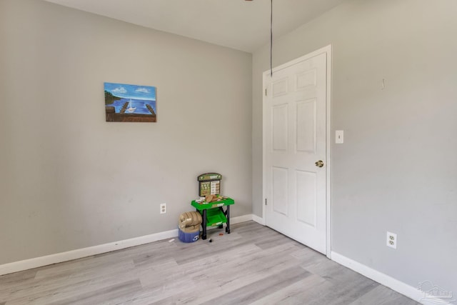 unfurnished room featuring wood finished floors and baseboards