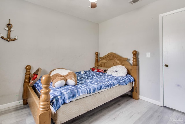 bedroom with wood finished floors, baseboards, and ceiling fan