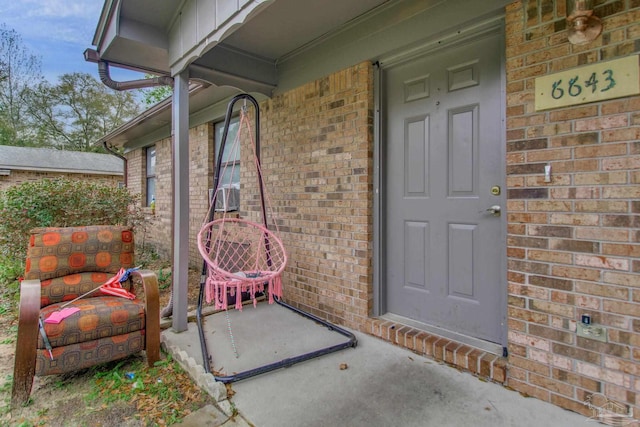 doorway to property with brick siding