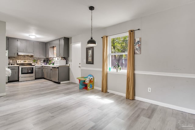 kitchen with light countertops, tasteful backsplash, appliances with stainless steel finishes, and gray cabinetry