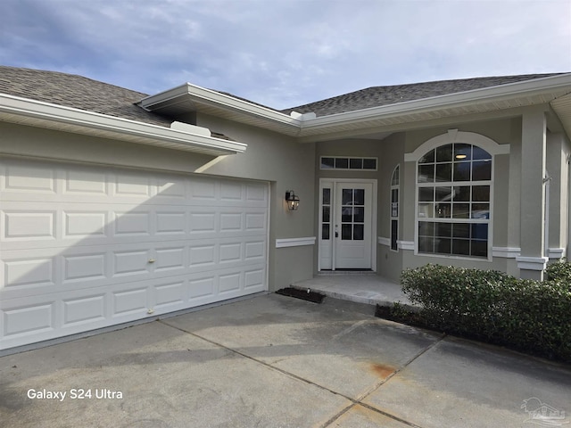 view of exterior entry with a garage