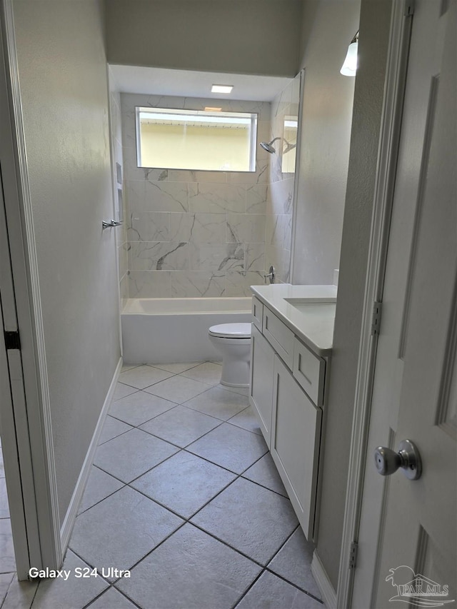 full bathroom featuring tile patterned flooring, vanity, tiled shower / bath combo, and toilet