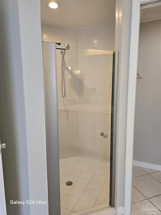 bathroom with tile patterned flooring and walk in shower