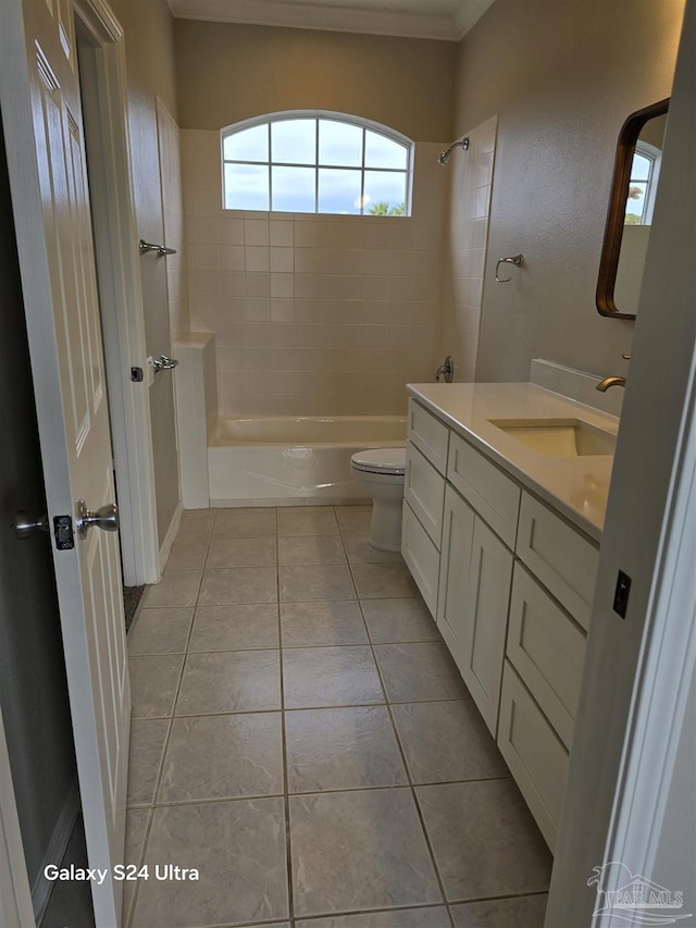 full bathroom with tile patterned floors, vanity, toilet, and tiled shower / bath combo