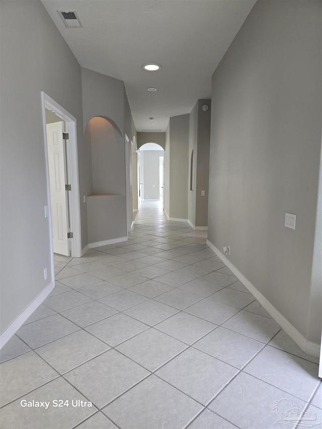 hall with light tile patterned floors