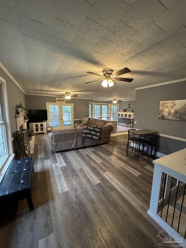 living room with dark wood-type flooring, ceiling fan, and ornamental molding