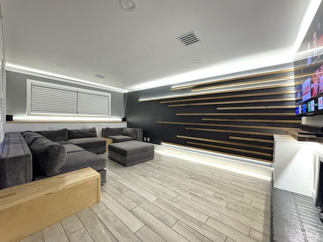 living area featuring visible vents and wood finished floors
