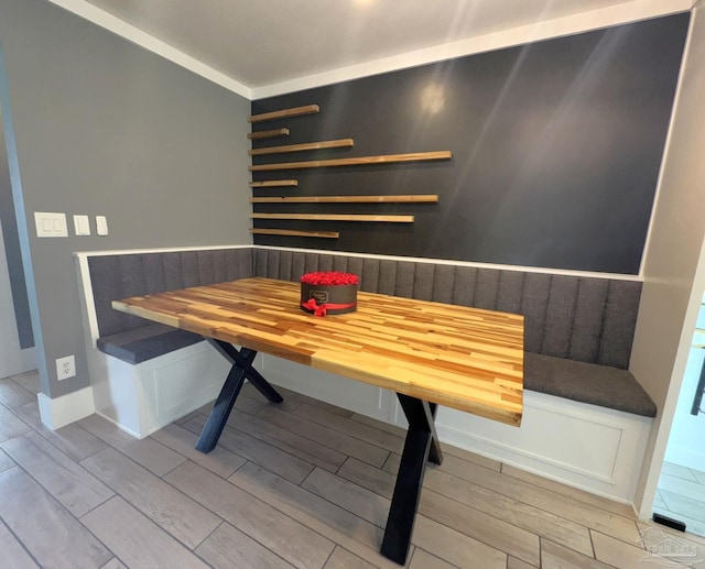 dining area featuring a sauna, breakfast area, and wood finish floors