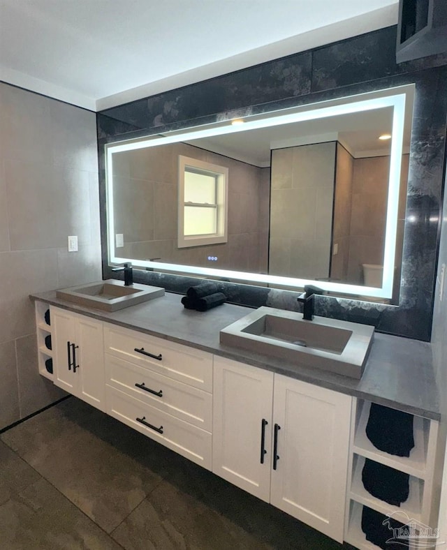 bathroom featuring a sink, tile walls, and double vanity