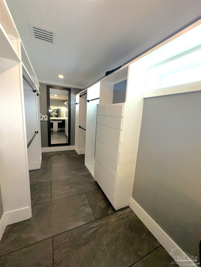 corridor with recessed lighting, visible vents, and baseboards
