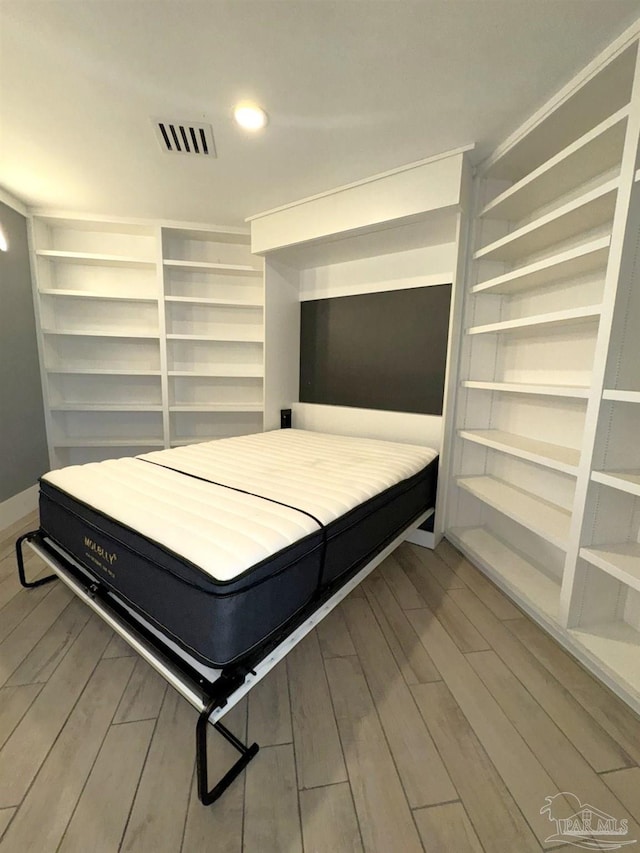 bedroom with recessed lighting, visible vents, and wood finished floors