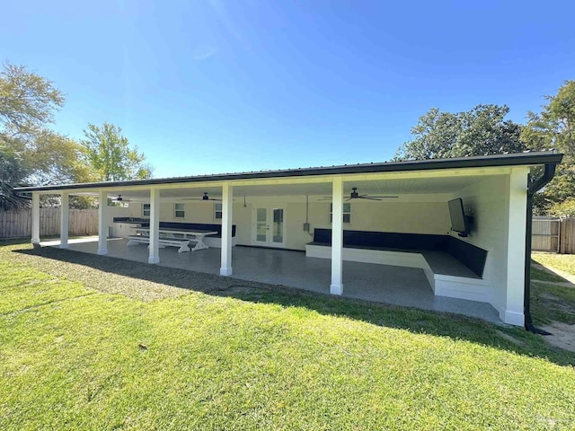 rear view of house featuring french doors, a ceiling fan, a patio area, a yard, and fence