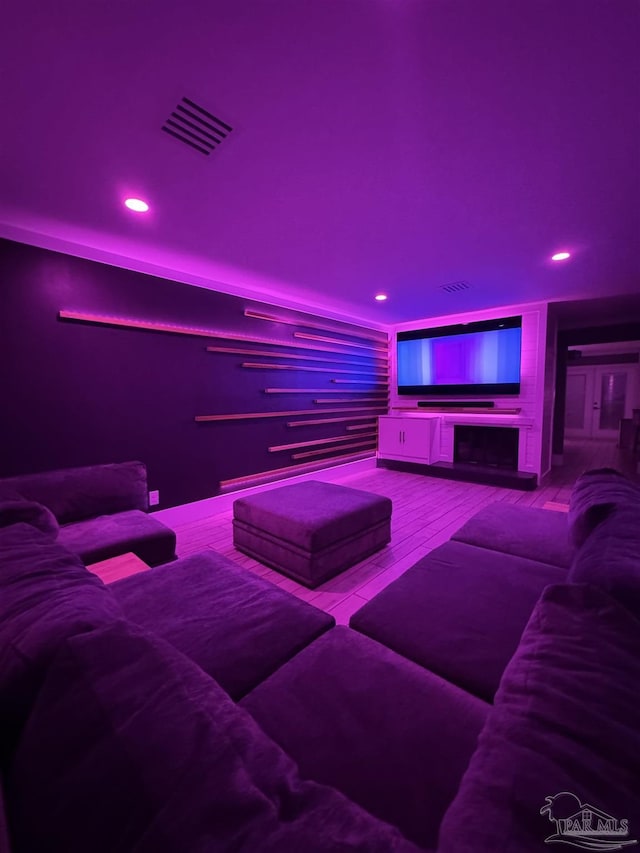 cinema with visible vents, recessed lighting, and wood finished floors