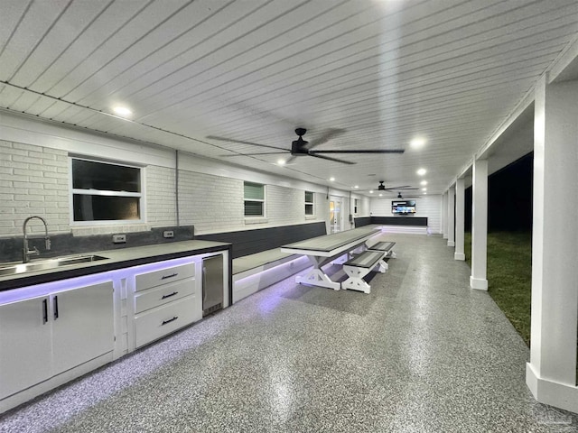 view of patio / terrace with area for grilling, a sink, and a ceiling fan