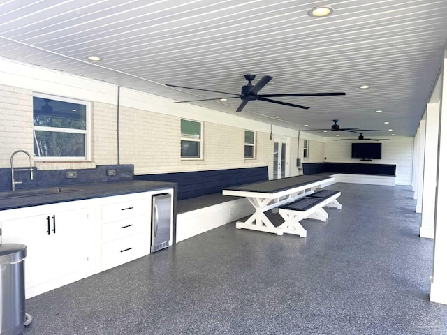 view of patio featuring outdoor dining space, a sink, exterior kitchen, and ceiling fan