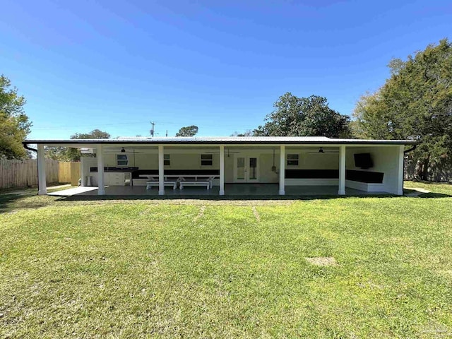 rear view of property with ceiling fan, a yard, a patio area, fence, and french doors