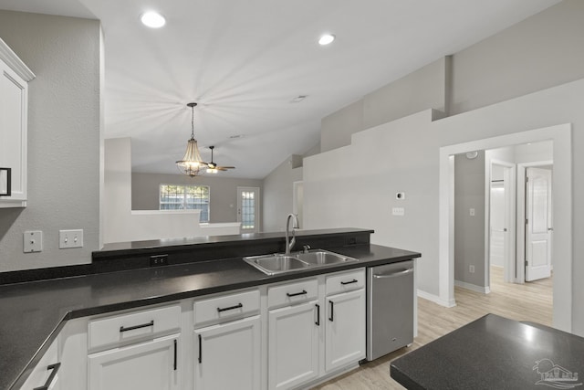 kitchen with a sink, dark countertops, white cabinetry, light wood-style floors, and dishwasher