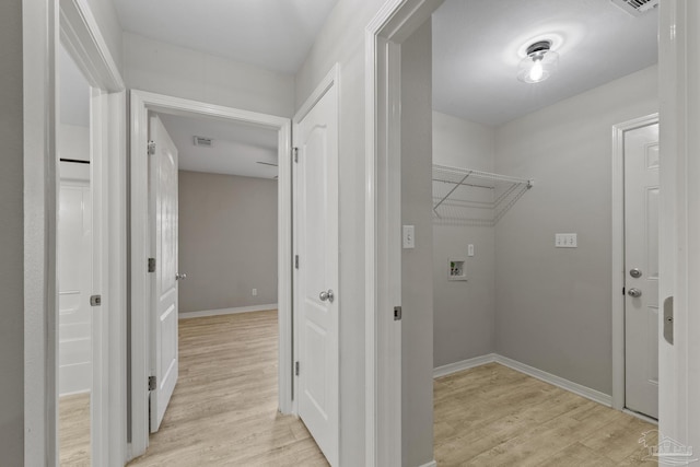 washroom with visible vents, baseboards, washer hookup, laundry area, and light wood-style floors