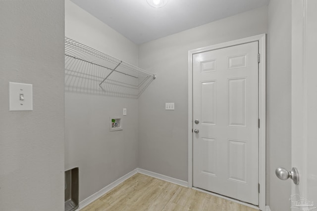 laundry area with washer hookup, laundry area, light wood-style floors, and baseboards