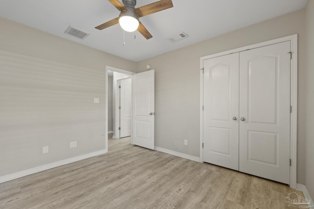 unfurnished bedroom with visible vents, baseboards, light wood-style floors, and a closet