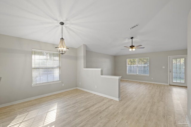 unfurnished room featuring a healthy amount of sunlight, visible vents, and light wood-type flooring