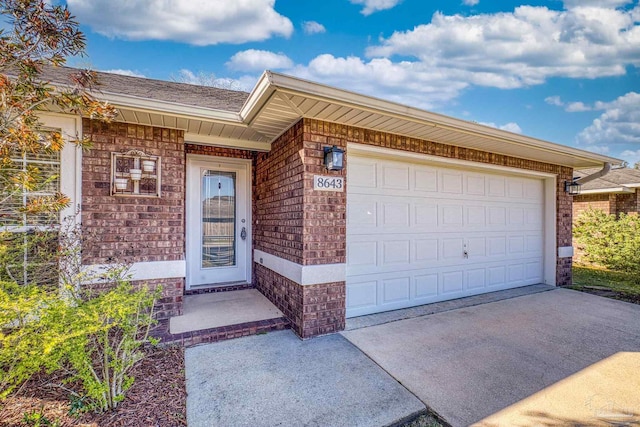 exterior space with a garage, brick siding, and driveway