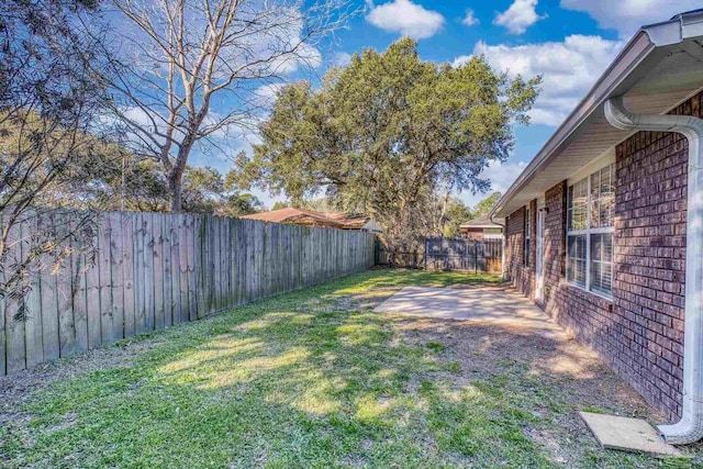 view of yard featuring a patio and a fenced backyard