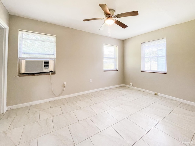 unfurnished room with ceiling fan, cooling unit, and baseboards