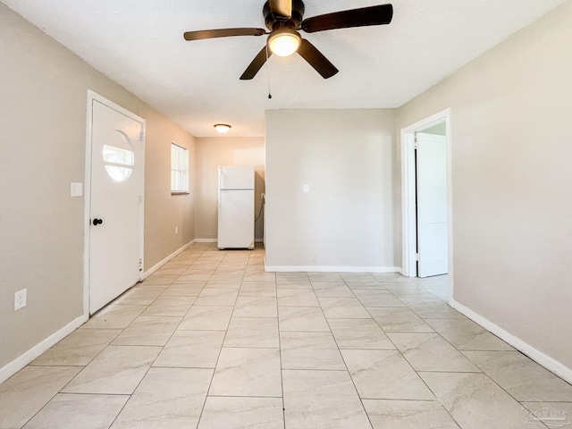 unfurnished room featuring baseboards and a ceiling fan