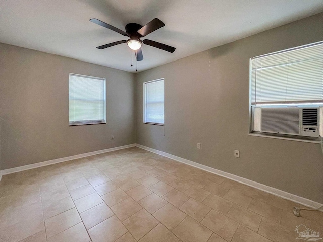 unfurnished room featuring ceiling fan, light tile patterned floors, cooling unit, and baseboards