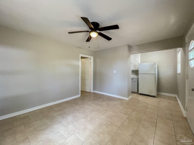 spare room featuring ceiling fan and baseboards